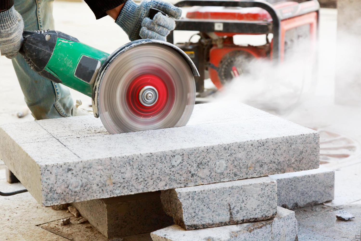 closeup-worker-cutting-granite-slab-with-grinder-dust-while-grinding-stone-pavement-002