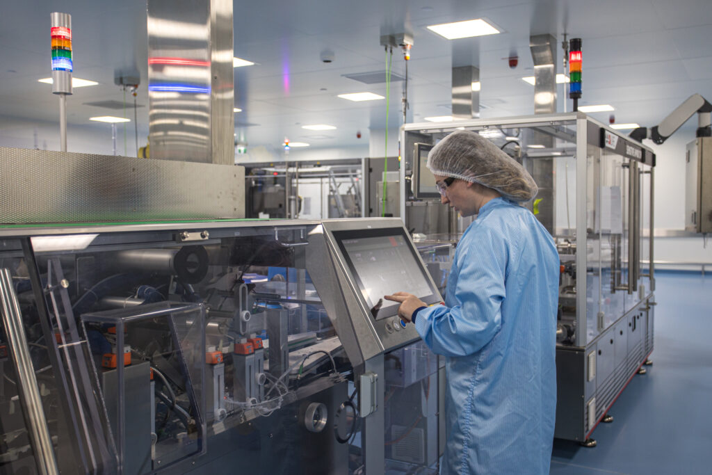 women at pharmaceutical vaccine filling line